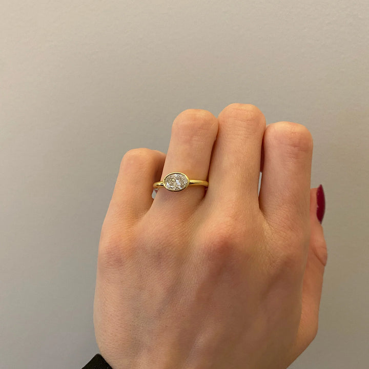 elegant oval diamond ring, oval diamond ring for her, oval cut diamond gold band, custom oval diamond ring, modern oval engagement ring, oval cut diamond with side stones, oval diamond three stone ring, oval cut diamond ring setting, oval diamond prong setting, luxury oval diamond ring