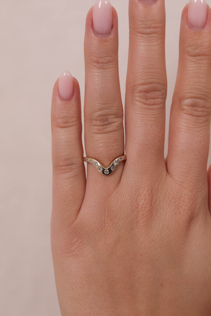 0.18 TCW Round Curved Diamond Wedding Band