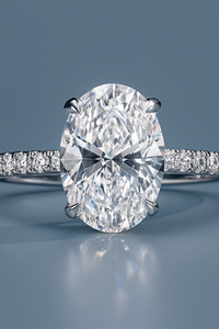 Oval 2.0ct IGI Certified Lab Grown Diamond Engagement Rings Put on Blue Surface